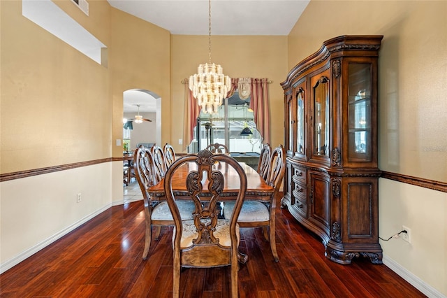 28390 Openfield Loop, Wesley Chapel, FL 33543 - dining room featuring a chandelier, arched walkways, dark wood finished floors, and baseboards