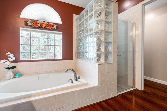 28390 Openfield Loop, Wesley Chapel, FL 33543 - bathroom featuring a shower stall, a bath, and wood finished floors