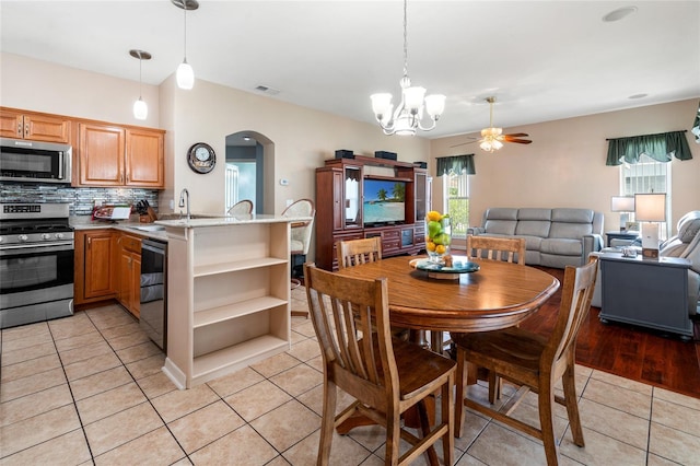 28390 Openfield Loop, Wesley Chapel, FL 33543 - dining room with arched walkways, light tile patterned floors, ceiling fan, and a chandelier