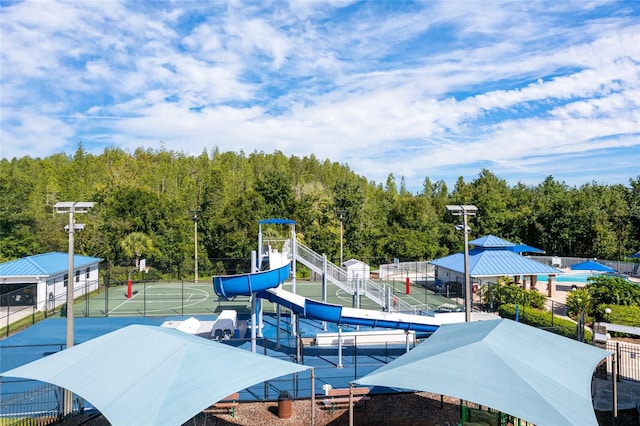 28390 Openfield Loop, Wesley Chapel, FL 33543 - view of jungle gym with a wooded view, community basketball court, and a tennis court