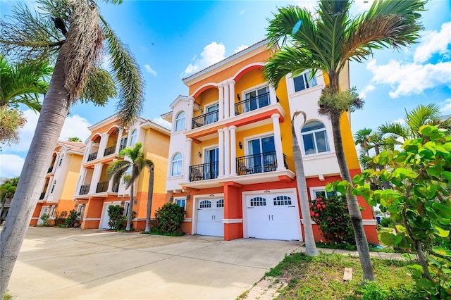 17817 Gulf Blvd Unit A, Saint Petersburg, FL 33708 - view of front of home with stucco siding, driveway, an attached garage, and a balcony