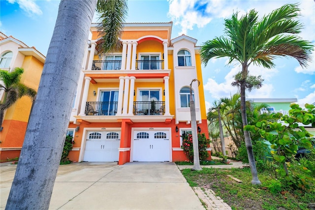 17817 Gulf Blvd Unit A, Saint Petersburg, FL 33708 - view of front of property featuring a balcony, concrete driveway, stucco siding, and an attached garage