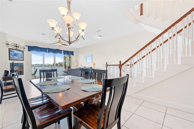 17817 Gulf Blvd Unit A, Saint Petersburg, FL 33708 - dining room with light tile patterned floors, a chandelier, stairway, and baseboards