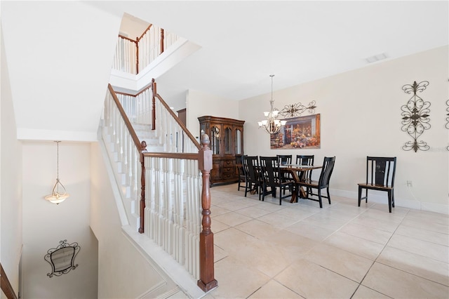 17817 Gulf Blvd Unit A, Saint Petersburg, FL 33708 - dining space with a towering ceiling, a chandelier, light tile patterned floors, stairway, and baseboards