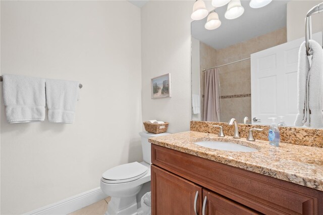 17817 Gulf Blvd Unit A, Saint Petersburg, FL 33708 - bathroom featuring vanity, a shower with curtain, toilet, tile patterned flooring, and baseboards