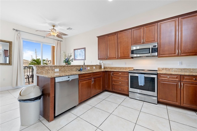 17817 Gulf Blvd Unit A, Saint Petersburg, FL 33708 - kitchen with appliances with stainless steel finishes, a sink, ceiling fan, a peninsula, and light stone counters