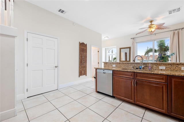 17817 Gulf Blvd Unit A, Saint Petersburg, FL 33708 - kitchen with dishwasher, a sink, ceiling fan, baseboards, and light stone counters