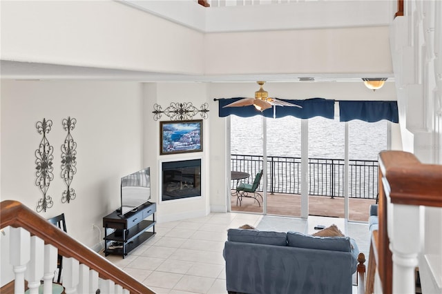 17817 Gulf Blvd Unit A, Saint Petersburg, FL 33708 - tiled living area featuring ceiling fan, a glass covered fireplace, and baseboards