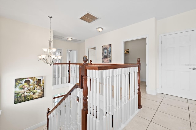 17817 Gulf Blvd Unit A, Saint Petersburg, FL 33708 - corridor with an upstairs landing, a chandelier, light tile patterned flooring, and baseboards