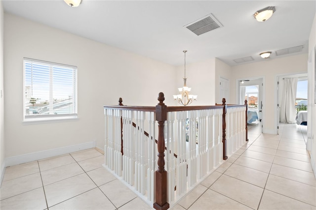 17817 Gulf Blvd Unit A, Saint Petersburg, FL 33708 - hall with a chandelier, light tile patterned floors, an upstairs landing, and baseboards