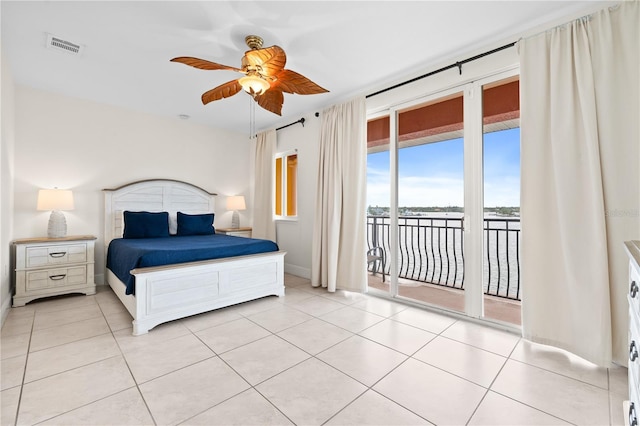 17817 Gulf Blvd Unit A, Saint Petersburg, FL 33708 - bedroom featuring access to exterior, light tile patterned floors, a water view, baseboards, and a ceiling fan