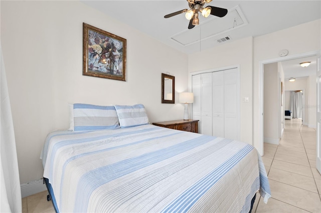17817 Gulf Blvd Unit A, Saint Petersburg, FL 33708 - bedroom featuring attic access, light tile patterned floors, a closet, a ceiling fan, and baseboards