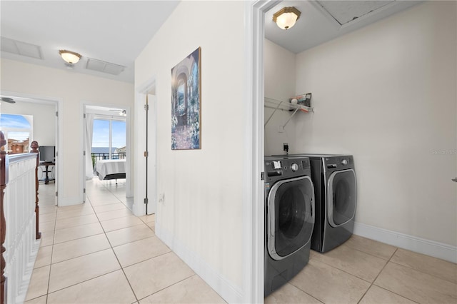 17817 Gulf Blvd Unit A, Saint Petersburg, FL 33708 - laundry area with separate washer and dryer, light tile patterned floors, and baseboards