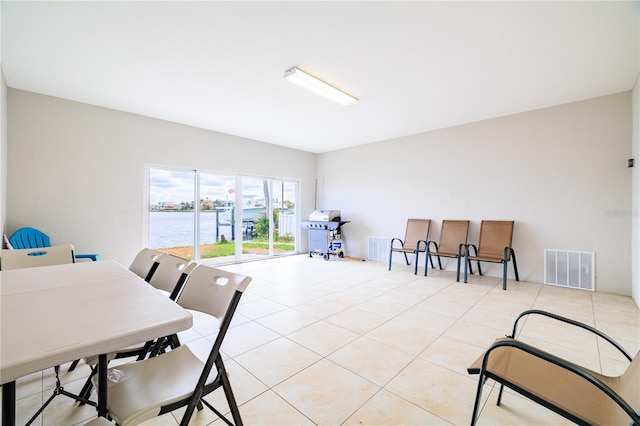 17817 Gulf Blvd Unit A, Saint Petersburg, FL 33708 - dining area featuring light tile patterned floors and a water view
