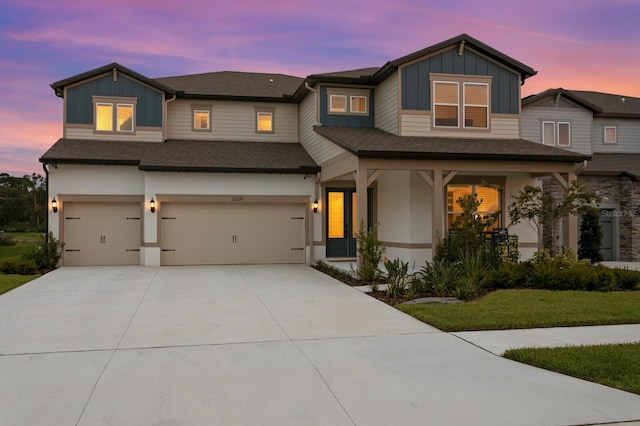 3559 Maple Bay Ln, Land O Lakes, FL 34638 - view of front of property with board and batten siding, an attached garage, concrete driveway, and a shingled roof