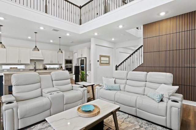 3559 Maple Bay Ln, Land O Lakes, FL 34638 - living area featuring recessed lighting, wood finished floors, a towering ceiling, and stairway