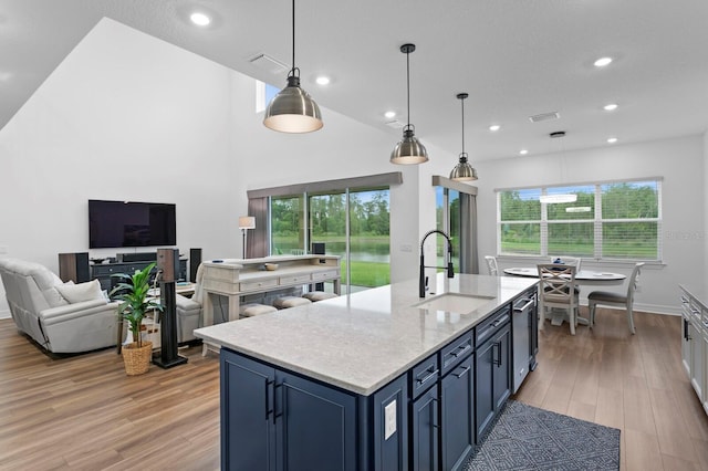 3559 Maple Bay Ln, Land O Lakes, FL 34638 - kitchen with light wood-type flooring, plenty of natural light, blue cabinets, recessed lighting, and open floor plan