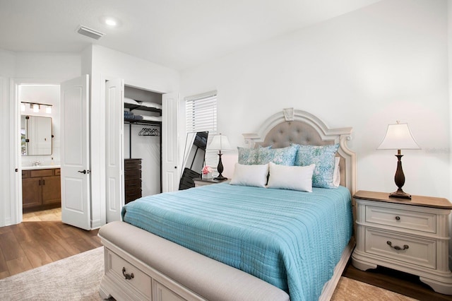 3559 Maple Bay Ln, Land O Lakes, FL 34638 - bedroom featuring wood finished floors, connected bathroom, and a closet