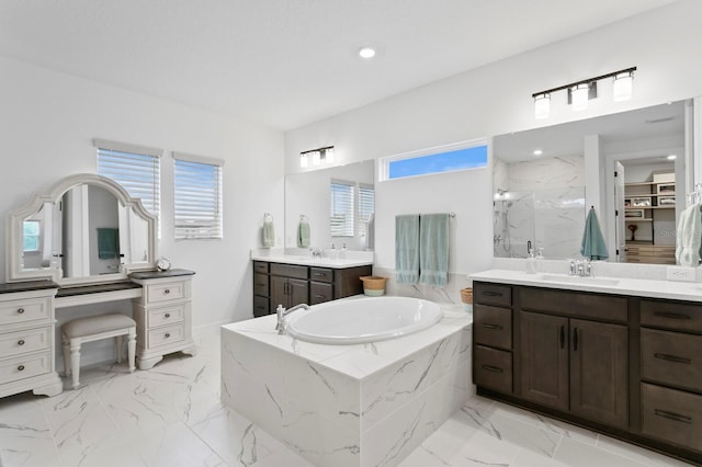 3559 Maple Bay Ln, Land O Lakes, FL 34638 - bathroom with a bath, a marble finish shower, two vanities, marble finish flooring, and recessed lighting