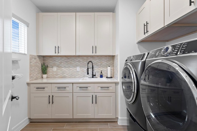 3559 Maple Bay Ln, Land O Lakes, FL 34638 - laundry room featuring washing machine and dryer, cabinet space, and light wood-style floors