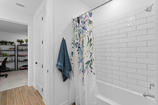3559 Maple Bay Ln, Land O Lakes, FL 34638 - bathroom with shower / bath combo with shower curtain and wood finish floors