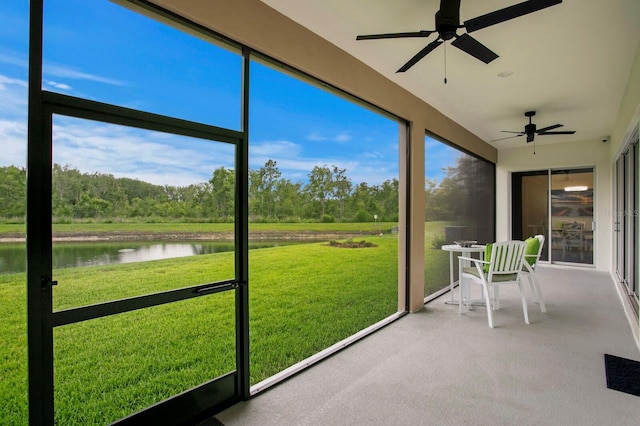 3559 Maple Bay Ln, Land O Lakes, FL 34638 - sunroom / solarium featuring ceiling fan and a water view