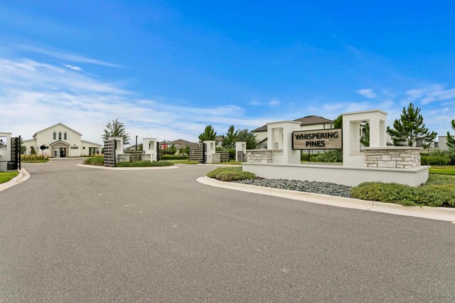 3559 Maple Bay Ln, Land O Lakes, FL 34638 - view of asphalt road with curbs and a gated entry