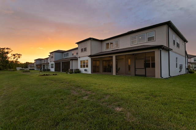 3559 Maple Bay Ln, Land O Lakes, FL 34638 - rear view of house featuring a sunroom and a lawn
