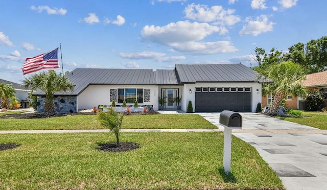 325 Gladstone Blvd, Englewood, FL 34223 - view of front of home with stucco siding, concrete driveway, a garage, and a front lawn