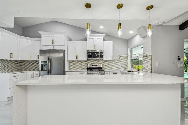 325 Gladstone Blvd, Englewood, FL 34223 - kitchen with appliances with stainless steel finishes, light countertops, backsplash, white cabinetry, and vaulted ceiling