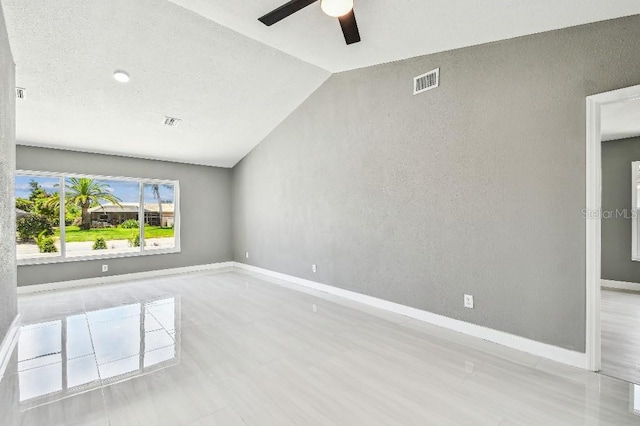 325 Gladstone Blvd, Englewood, FL 34223 - unfurnished room featuring a ceiling fan, lofted ceiling, and a textured wall