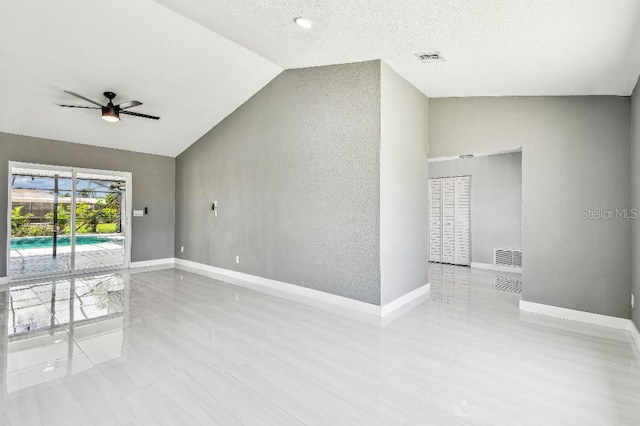 325 Gladstone Blvd, Englewood, FL 34223 - tiled spare room with vaulted ceiling, a ceiling fan, and a textured ceiling