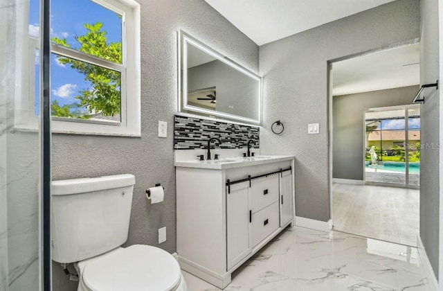 325 Gladstone Blvd, Englewood, FL 34223 - full bath featuring a textured wall, double vanity, and marble finish flooring