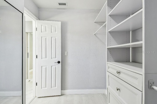 325 Gladstone Blvd, Englewood, FL 34223 - walk in closet with light wood-style floors