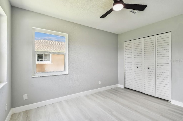 325 Gladstone Blvd, Englewood, FL 34223 - unfurnished bedroom featuring wood finished floors, ceiling fan, and a closet