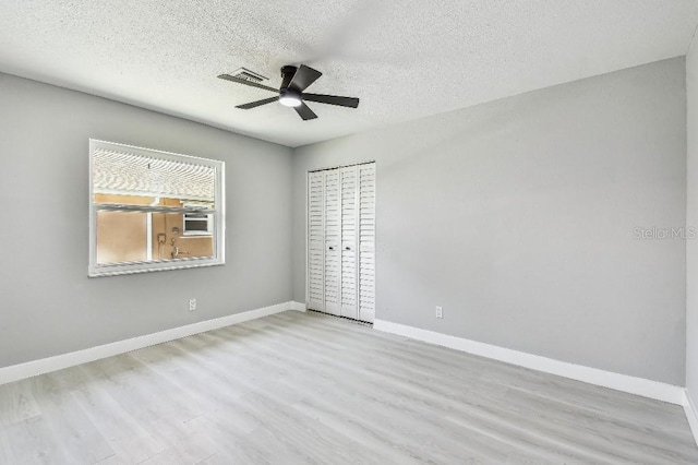 325 Gladstone Blvd, Englewood, FL 34223 - unfurnished bedroom with wood finished floors, a textured ceiling, and ceiling fan