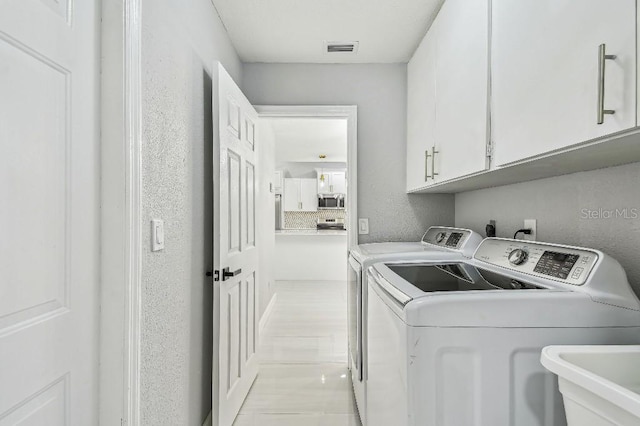 325 Gladstone Blvd, Englewood, FL 34223 - washroom with cabinet space and washer and clothes dryer