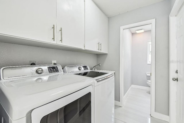 325 Gladstone Blvd, Englewood, FL 34223 - washroom featuring cabinet space and washer and clothes dryer
