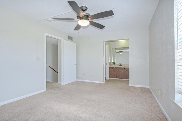 1799 N Highland Ave Unit 185, Clearwater, FL 33755 - unfurnished bedroom with light carpet, baseboards, and ensuite bathroom