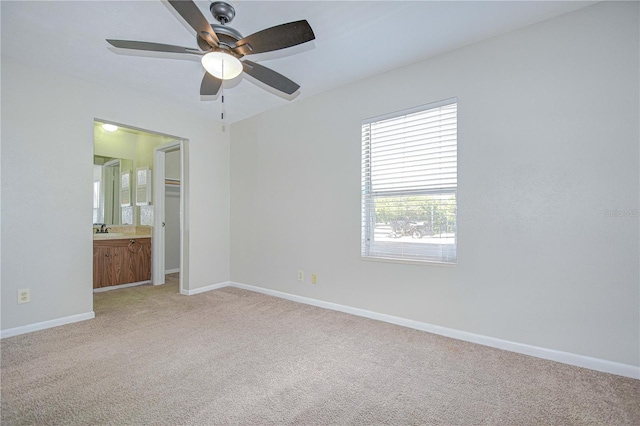 1799 N Highland Ave Unit 185, Clearwater, FL 33755 - unfurnished bedroom featuring a sink, light carpet, baseboards, ensuite bathroom, and a ceiling fan