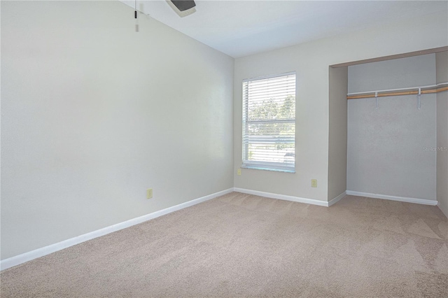 1799 N Highland Ave Unit 185, Clearwater, FL 33755 - unfurnished bedroom with light colored carpet, baseboards, and a closet