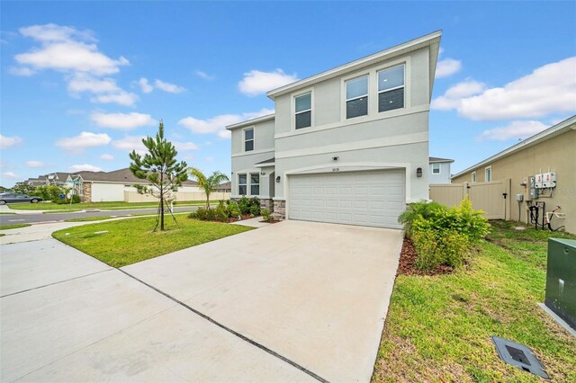 32136 Conchshell Sail St, Wesley Chapel, FL 33545 - view of front of property featuring an attached garage, stucco siding, stone siding, driveway, and a residential view