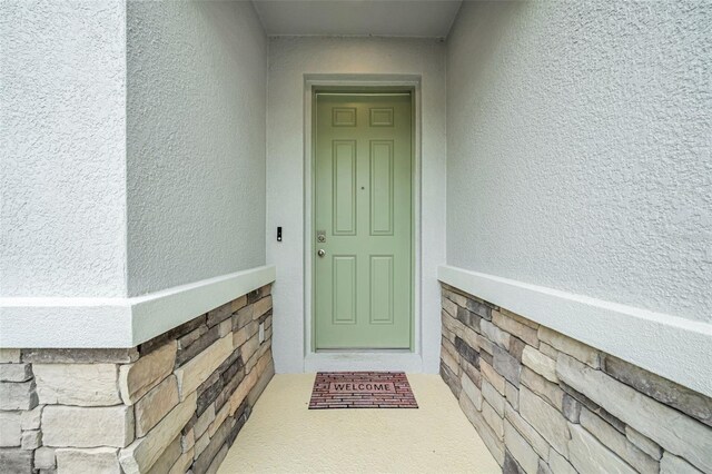 32136 Conchshell Sail St, Wesley Chapel, FL 33545 - view of exterior entry with stucco siding