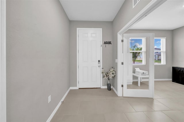 32136 Conchshell Sail St, Wesley Chapel, FL 33545 - foyer with baseboards and light tile patterned floors