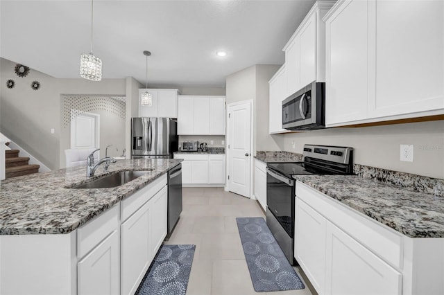 32136 Conchshell Sail St, Wesley Chapel, FL 33545 - kitchen featuring stainless steel appliances, a sink, white cabinetry, hanging light fixtures, and recessed lighting