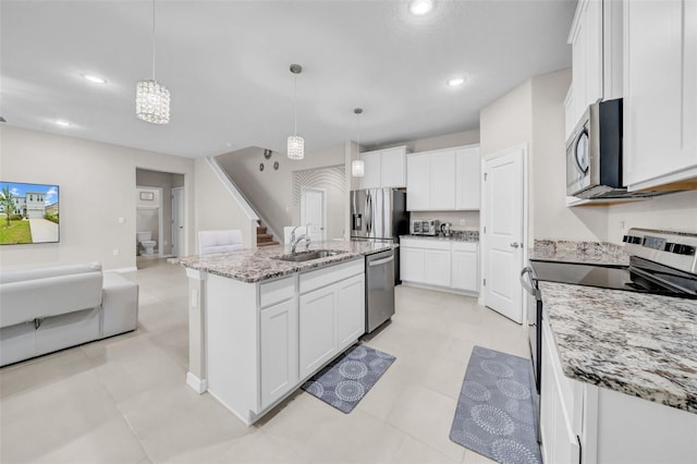 32136 Conchshell Sail St, Wesley Chapel, FL 33545 - kitchen with appliances with stainless steel finishes, a sink, open floor plan, white cabinetry, and recessed lighting