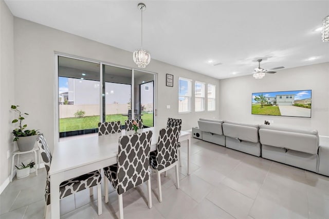 32136 Conchshell Sail St, Wesley Chapel, FL 33545 - dining space with light tile patterned floors, a chandelier, baseboards, and a ceiling fan