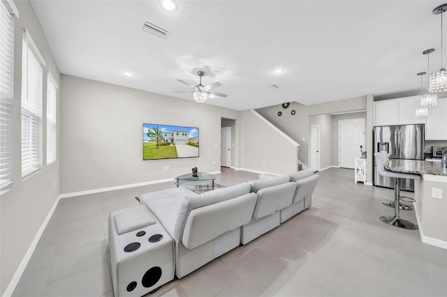 32136 Conchshell Sail St, Wesley Chapel, FL 33545 - living area with recessed lighting, ceiling fan, baseboards, light tile patterned flooring, and a chandelier