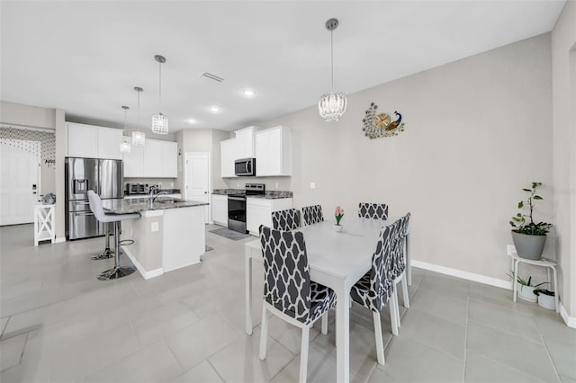 32136 Conchshell Sail St, Wesley Chapel, FL 33545 - dining area featuring a chandelier, baseboards, recessed lighting, and light tile patterned flooring