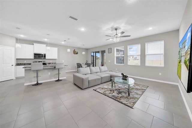 32136 Conchshell Sail St, Wesley Chapel, FL 33545 - living room featuring ceiling fan, baseboards, recessed lighting, and light tile patterned floors